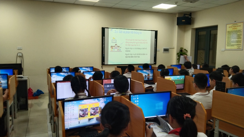 A group of people in a classroom using computers

Description automatically generated