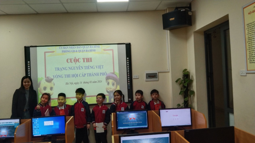 A group of children standing in front of a screen

Description automatically generated