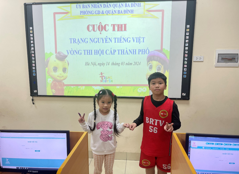 A child and child holding hands in front of a screen

Description automatically generated